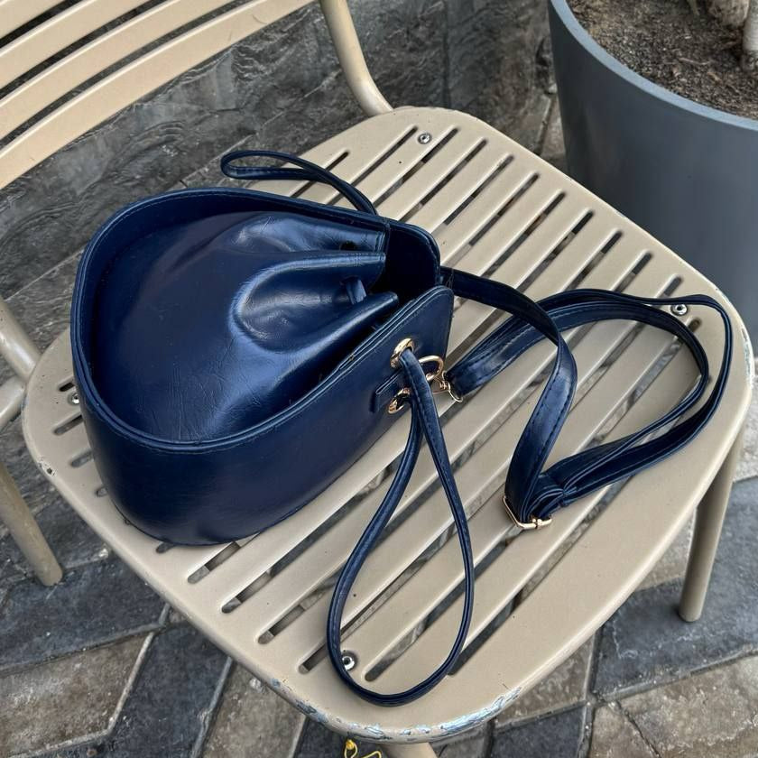 Navy blue midnight leather bucket bag with drawstring closure
