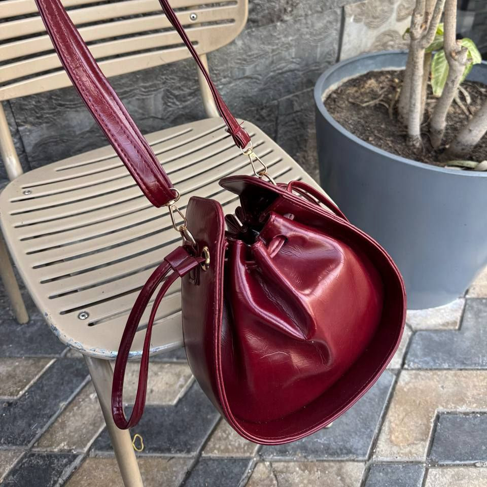 Burgundy wine red leather bucket bag with drawstring closure