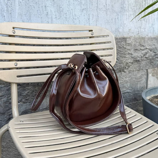 Dark brown leather bucket bag with shoulder strap